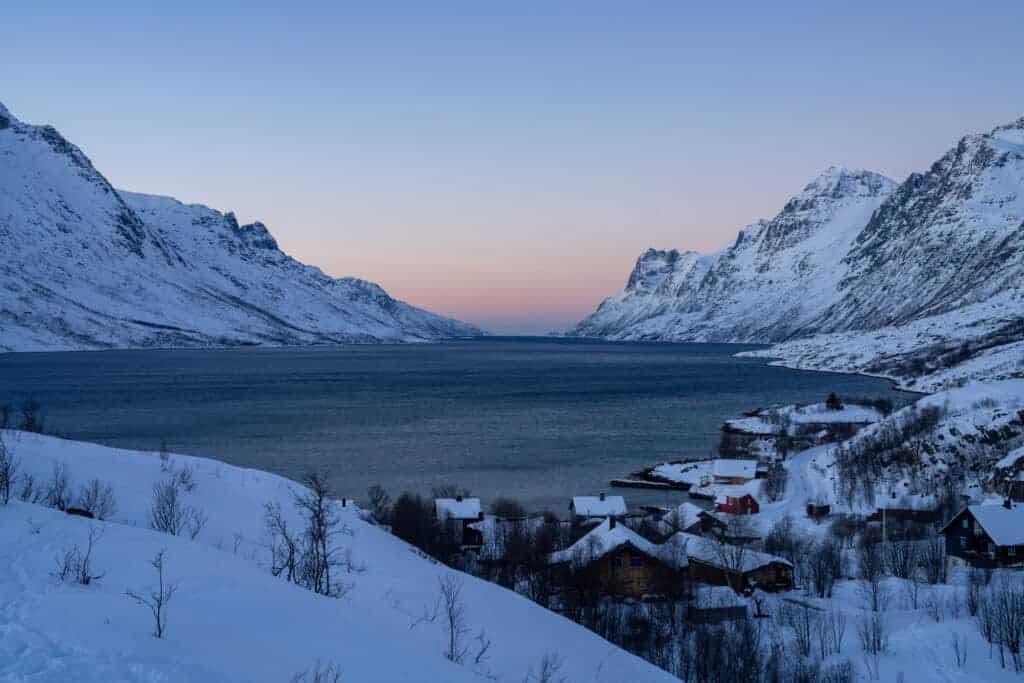 Home - Experience Tromsø Like a Local Snow-covered fjord and village near Tromsø at sunset