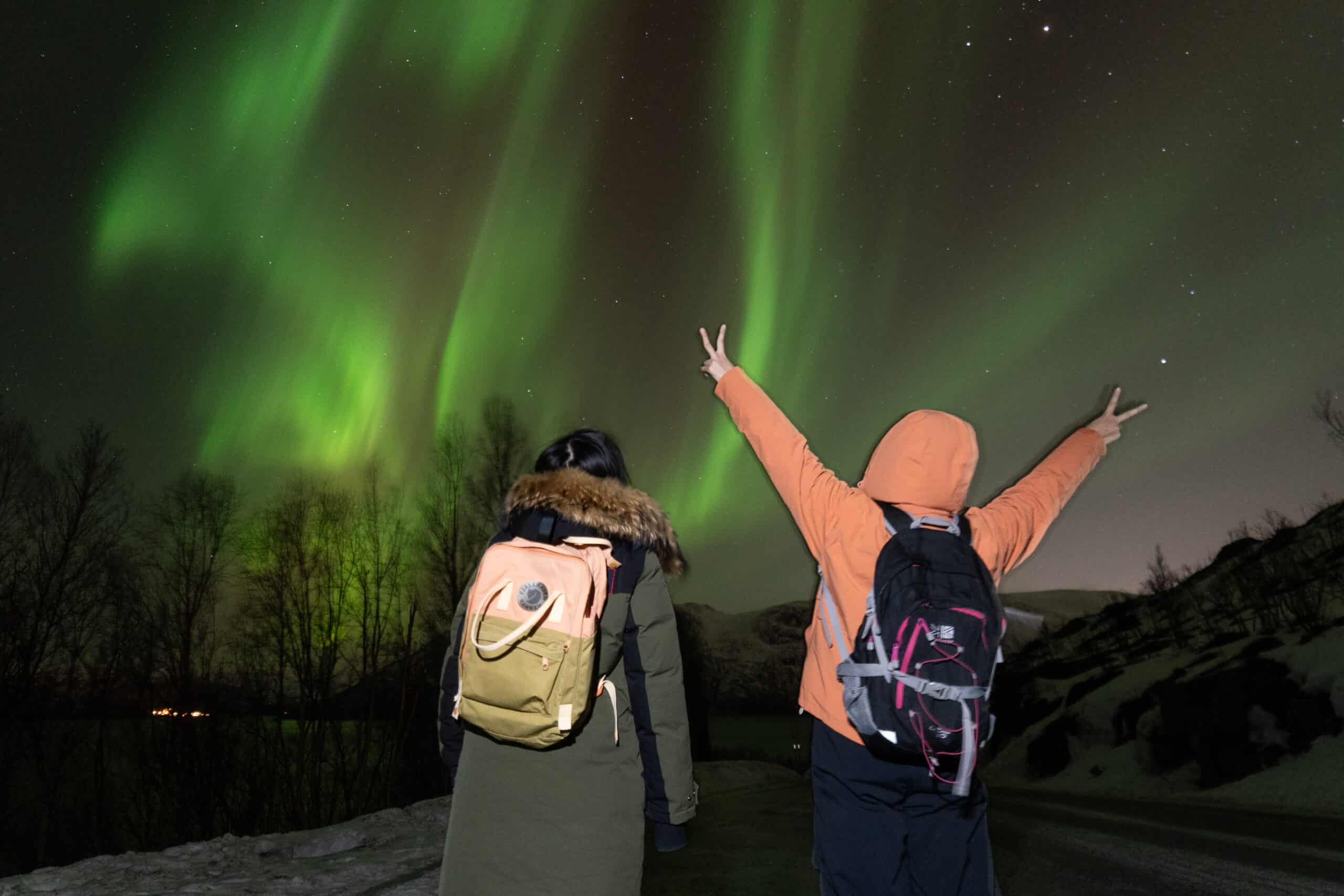 Northern Lights Forecast Norway: How to Read It Like a Local Guide - Experience Tromsø Like a Local People watching the Northern Lights in Tromsø with backpacks.