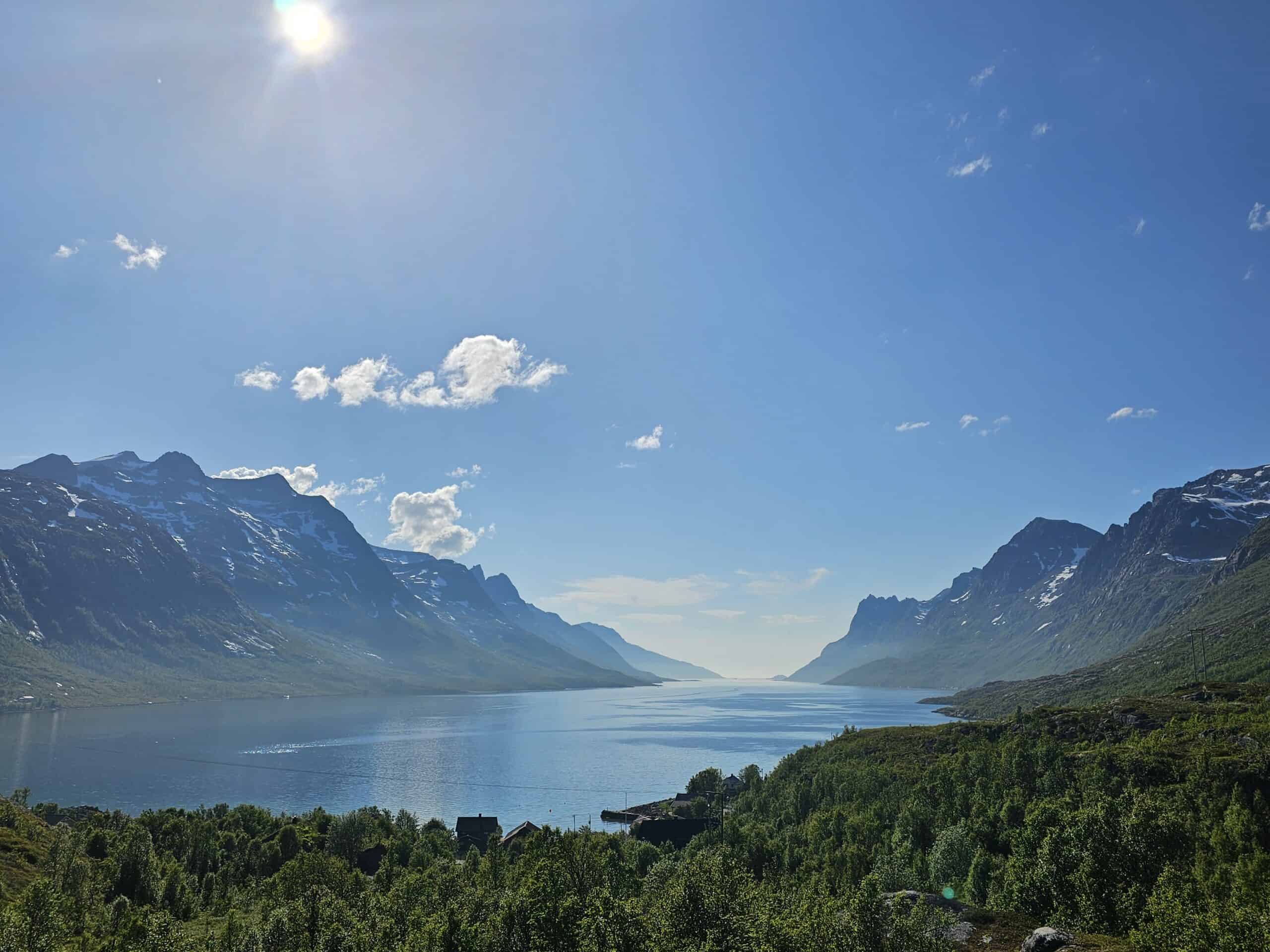 Beautiful Ersfjord view in Tromsø with mountains and clear blue sky.